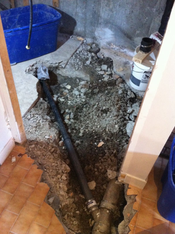 Busted up the concrete floor in the bathroom to get at the drainage.