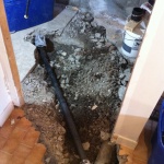 Busted up the concrete floor in the bathroom to get at the drainage.