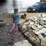 Fixing foundation cracks - Corina helps me break up some concrete!