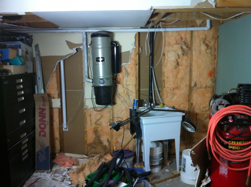 Ripping out the back of the garage to prepare for the new laundry room area.