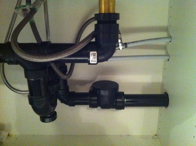 backflow installed under the sink to stop water drainage from the washing machine come up in to the sink.