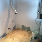 Putting in the new ceramic for the laundry room area.