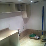 Installing cabinets and counter top.