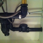 backflow installed under the sink to stop water drainage from the washing machine come up in to the sink.