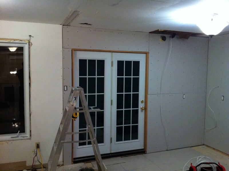 Drywall done around the back patio doors.