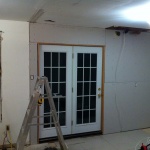 Drywall done around the back patio doors.