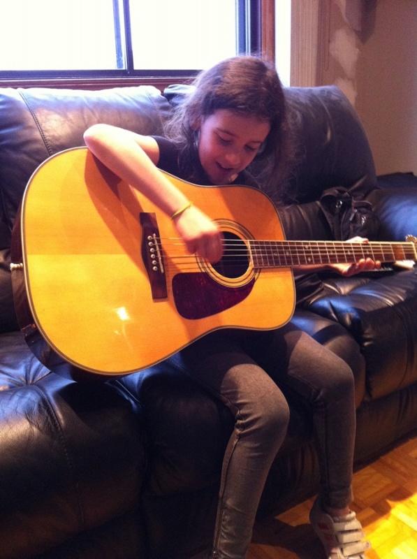 Corina playing my guitar