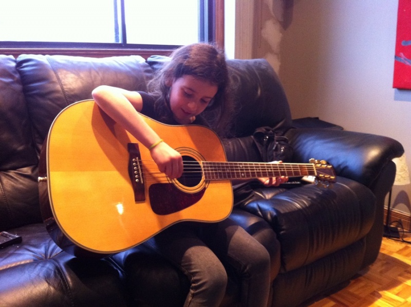 Corina playing my guitar