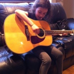 Corina playing my guitar